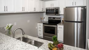 Rochester apartment for rent - a kitchen with stainless steel appliances and granite counter tops