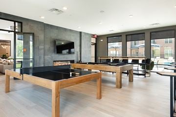 Loveland apartment for rent - A modern living room with a black table and a fireplace.