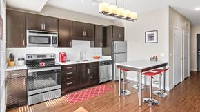 Minneapolis apartment for rent - a modern kitchen with stainless steel appliances and a white counter top at Red 20 Apartments, Minneapolis, MN