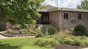 Fridley apartment for rent - a brick building with a tree in front of it