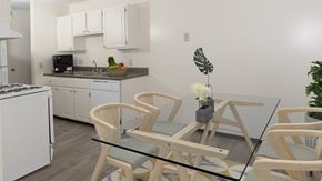 Fridley apartment for rent - a dining room with a glass table and chairs in a kitchen