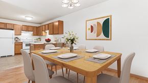 Isanti apartment for rent - a dining room with a wooden table and chairs