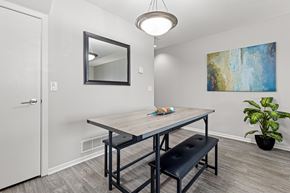 Lakeville townhouse for rent - A dining room with a wooden table and bench.