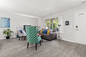Lakeville townhouse for rent - A living room with a grey couch and a green and white chair.
