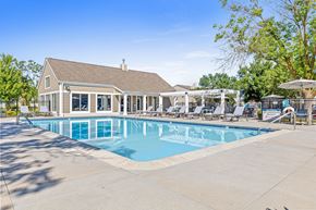 Lakeville townhouse for rent - A large swimming pool with a building in the background.