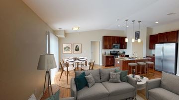 Grand Forks apartment for rent - a living room with a couch and a kitchen with a table and chairs