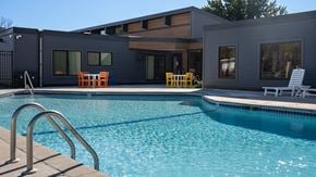 Woodbury apartment for rent - a swimming pool with a house in the background at The Bosk Apartment Homes, Minnesota
