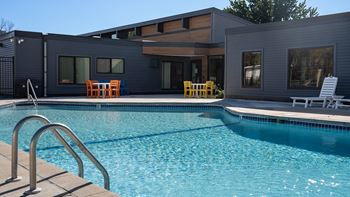 A swimming pool with a house in the background