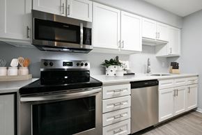 Lincoln apartment for rent - Kitchen with white cabinets and stainless steel appliances at The Donovan Apartment Homes, Nebraska