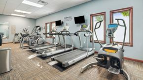 Grand Forks apartment for rent - A gym with treadmills, elliptical machines, and other exercise equipment.