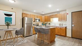Grand Forks apartment for rent - A modern kitchen with wooden cabinets and a large island.