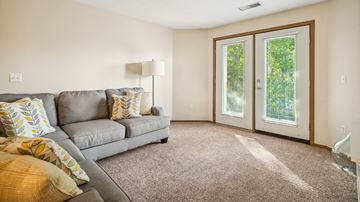Grand Forks apartment for rent - A living room with a grey couch and a lamp.