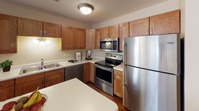 Jamestown apartment for rent - Kitchen with light wooden cabinets, central island and stainless steel appliances