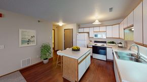 Jamestown apartment for rent - Side view of a spacious kitchen with white cabinetry and ample amounts of storage space.
