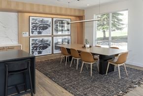 Rochester apartment for rent - a dining room with a table and chairs in front of a window