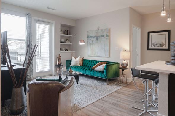 Denver apartment for rent - Open living area with stylish plank flooring throughout the space and large windows.