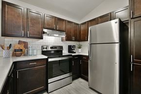 Omaha apartment for rent - Kitchen with Wood Cabinets and Stainless Steel Fridge