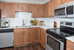 Rochester apartment for rent - Kitchen with Wood Cabinets and White Counter Tops