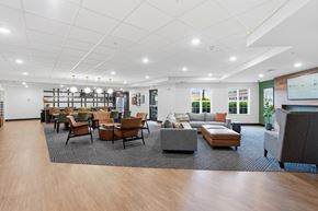 Grand Forks apartment for rent - A spacious waiting room with wooden floors and a variety of seating options.