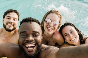 Omaha apartment for rent - Four people are smiling and taking a selfie in a pool.
