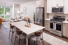 Minneapolis apartment for rent - an open kitchen and living room with a dining table and chairs
