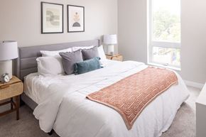 Minneapolis apartment for rent - a bedroom with a large bed and two windows