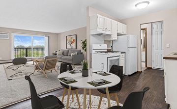Roseville apartment for rent - A modern kitchen with a dining table set for two.