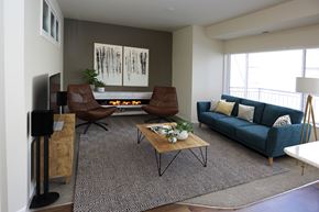 Bismarck apartment for rent - A living room with a fireplace and a painting on the wall.