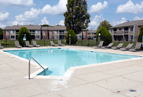 Indianapolis apartment for rent - a swimming pool with chaise lounge chairs and apartment buildings in the background