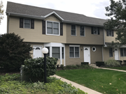 Mishawaka townhouse for rent - a house with a lawn and a lamp post in front of it