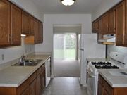 Mishawaka townhouse for rent - a kitchen with a white refrigerator freezer next to a stove top oven