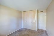 Morris apartment for rent - A bedroom with a carpeted floor and a white door.