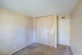 Morris apartment for rent - A bedroom with a carpeted floor and a white door.
