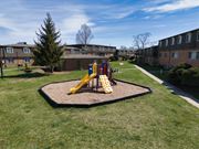 Indianapolis apartment for rent - a playground in a yard in front of an apartment building