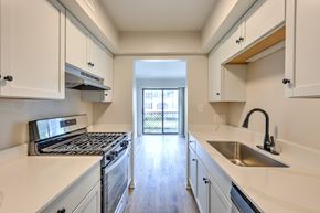 Mishawaka apartment for rent - A kitchen with white cabinets and a stainless steel sink.