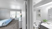 Trotwood apartment for rent - a bedroom with a bed and a bathroom with a toilet and a sink