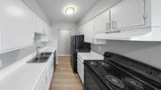 Indianapolis apartment for rent - a kitchen with white cabinets and black appliances and a sink