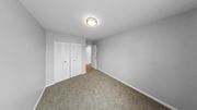 Indianapolis apartment for rent - a bedroom with white walls and carpet and white closet doors