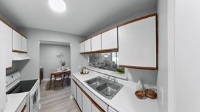 Mishawaka apartment for rent - a kitchen with white counter tops and a stainless steel sink at The Element @ St Andrews, Indiana, 46545