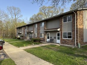 Elkhart apartment for rent - A residential building with a grey facade and a white door.