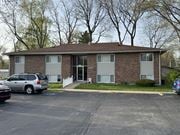 Elkhart apartment for rent - A small brick building with a parking lot in front.