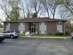 Elkhart apartment for rent - A small brick building with a parking lot in front.