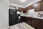 Matteson apartment for rent - a kitchen with black appliances and wooden cabinets