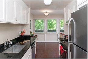 Burlingame apartment for rent - A kitchen with black countertops and white cabinets.