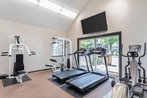 Concord apartment for rent - A gym with treadmills, exercise bikes, and a television.