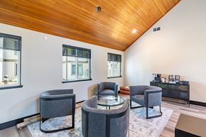 Concord apartment for rent - A living room with a wooden ceiling and grey chairs.