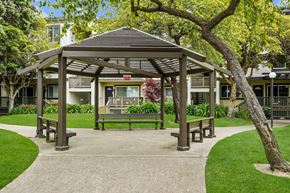 South San Francisco apartment for rent - a park with a gazebo and benches in front of a building