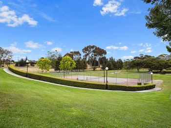 Tennis court surrounded by green space