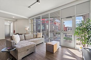 A modern living room with a grey sofa and a wooden coffee table.