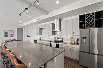 A modern kitchen with a large island and stainless steel appliances.